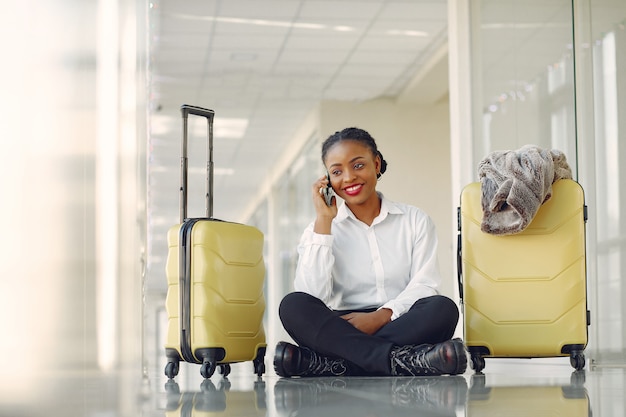 Free photo black woman with suitcase at the airport