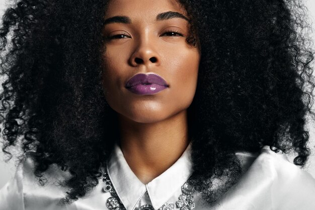 Black woman with trendy violet glossy lips