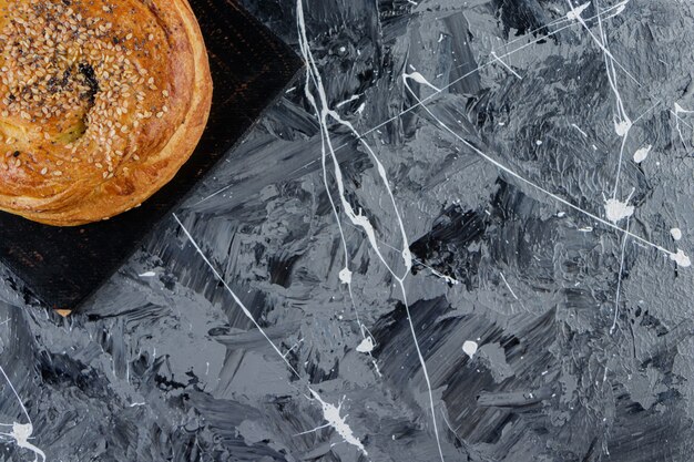 A black wooden board of Azerbaijani gohal on a marble table . 