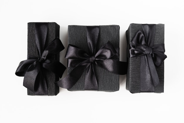 Free photo black wrapped gifts on plain background