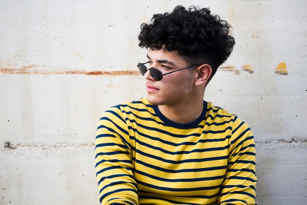 Black young male in sunglasses and striped shirt