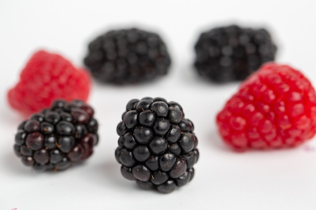 Blackberries and raspberries isolated on a white background