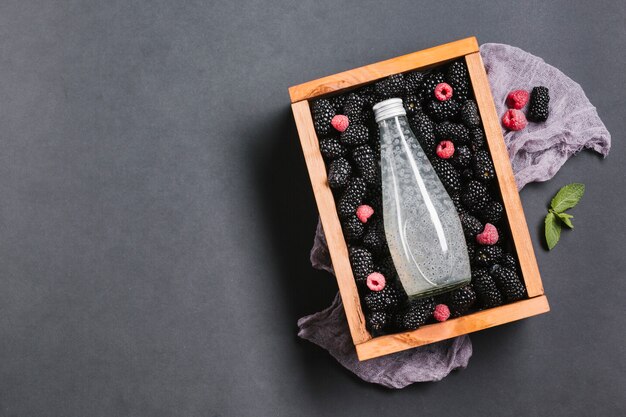 Blackberry juice bottle on wooden box