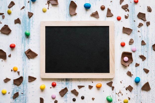 Blackboard amidst chocolate and sweets