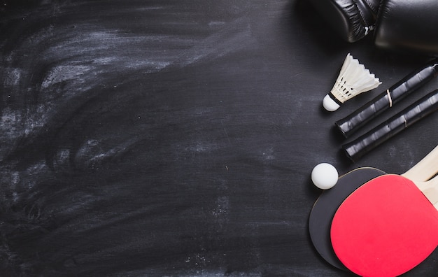 Blackboard background with ping pong rackets and ball