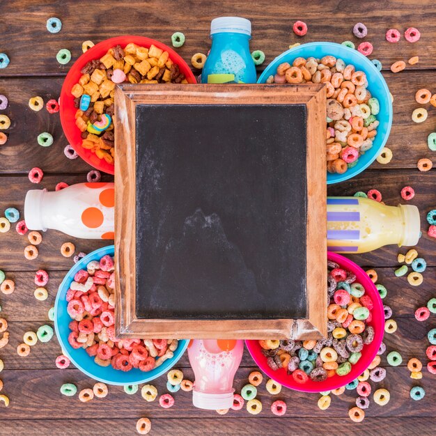 Blackboard on bright bowls of cereals and bottles