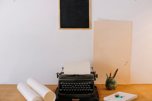 Blackboard hanging over typewriter