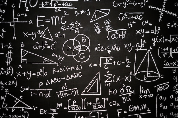 Blackboard inscribed with scientific formulas and calculations 