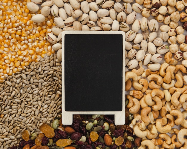 Blackboard lying on nuts and seeds