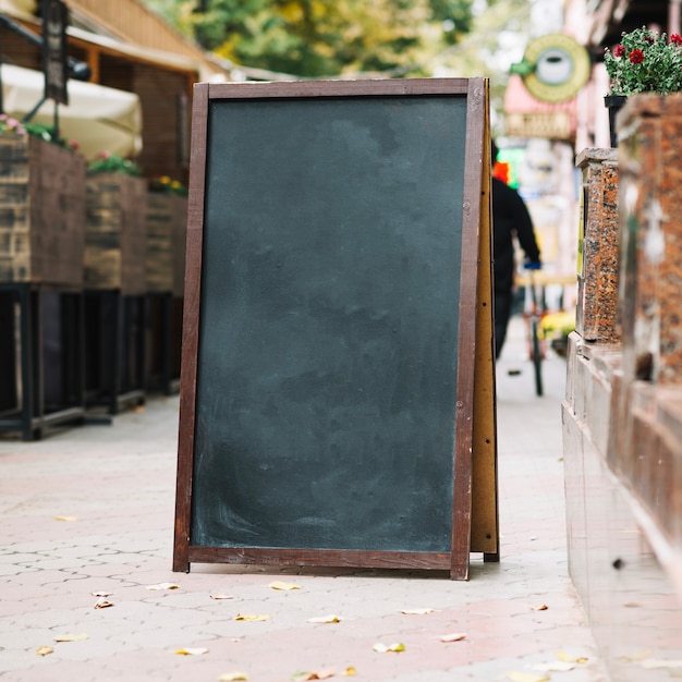 Free photo blackboard near cafe