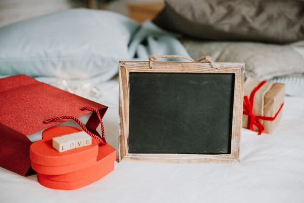 Blackboard near paper bag and presents