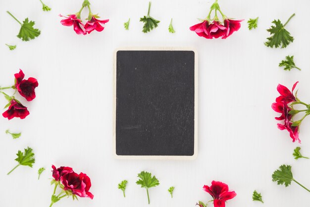 Blackboard placed in flowers