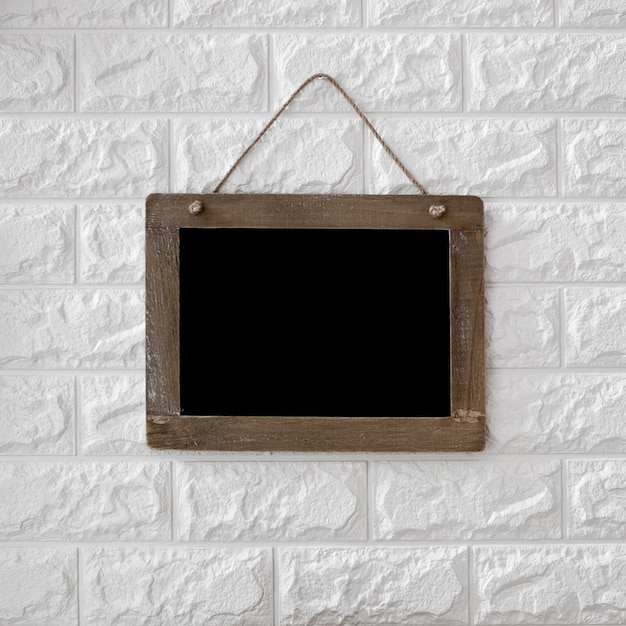 Free photo blackboard on textured brick wall background