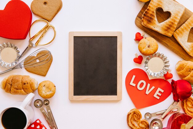 Blackboard between Valentine's day pastry