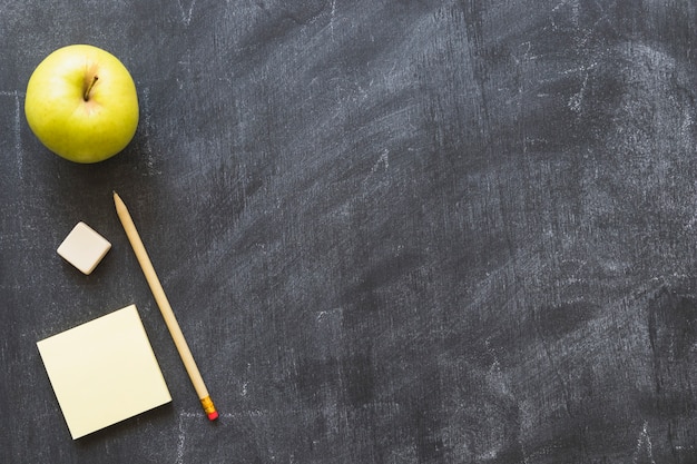 Blackboard with apple and stationery