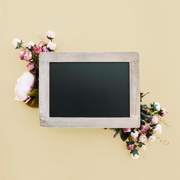 blackboard with beautiful flowers on gold wedding background