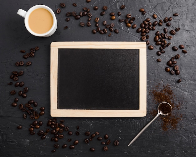 Free photo blackboard with coffee beans and spoon