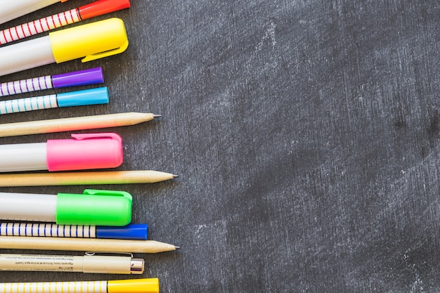 Blackboard with row of drawing pens