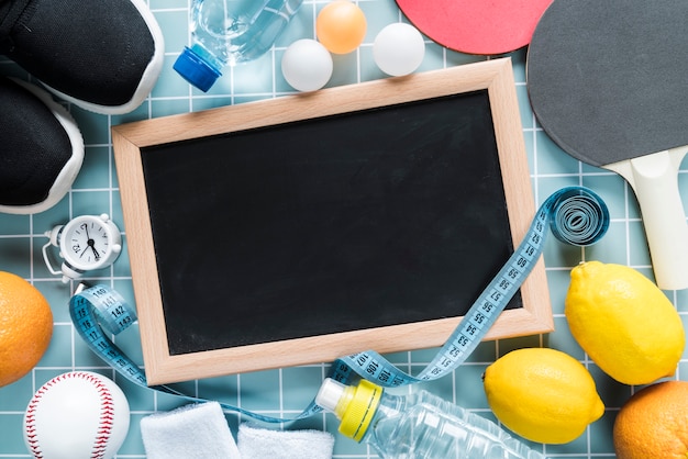 Blackboard with sport items around