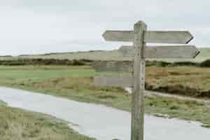 Free photo blank arrows of a rural street post