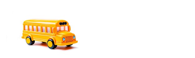 Free photo blank banner of yellow toy school bus in profile on white background