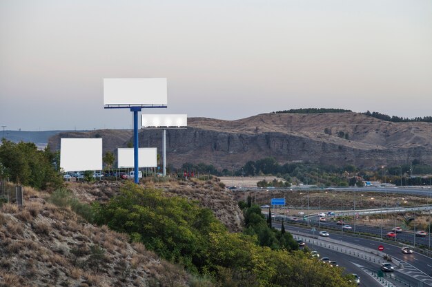 Blank billboards for new advertisement on mountain near the highway