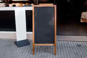 Free photo blank blackboard menu and white billboard in front of the restaurant at street