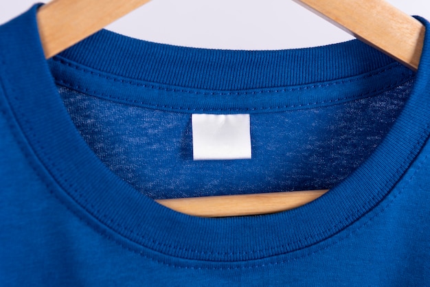 Free photo blank blue t-shirt and blank label tag for advertising.