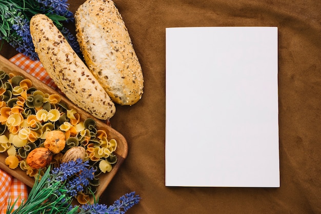 Blank book mockup with bread and pasta
