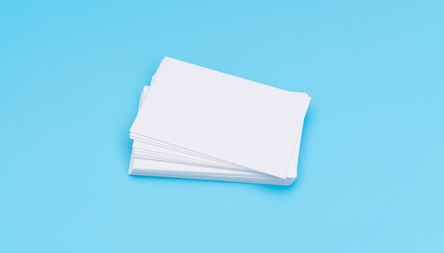 Blank business card on blue background .
