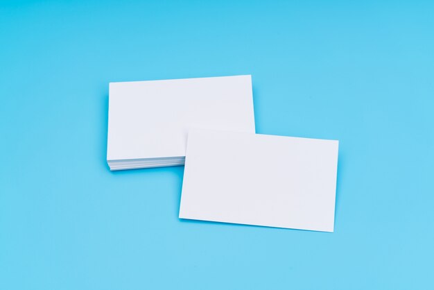 Blank business card on blue background .