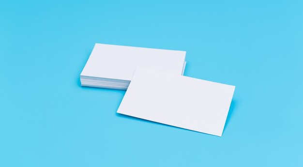 Blank business card on blue background .