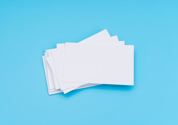 Blank business card on blue background .