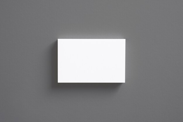 Blank business cards stack isolated on grey top view