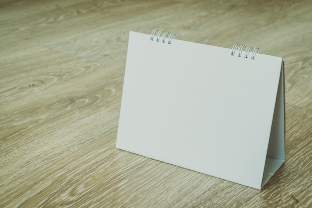 Blank calendar on wooden background