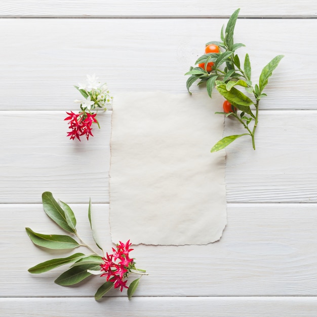 Blank card in arrangement with flowers