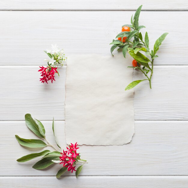 Blank card in arrangement with flowers