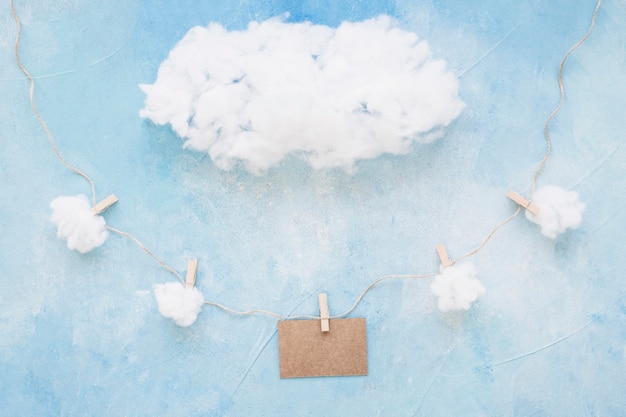 Blank card decorated with clouds on color backdrop