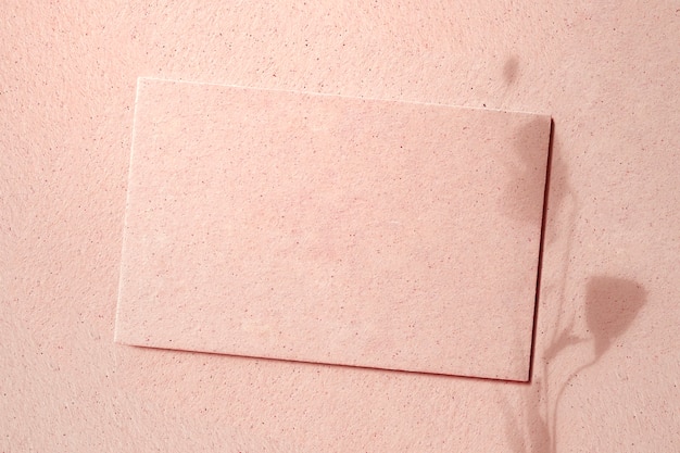 Blank card on a pink concrete
