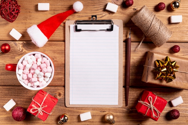 Blank clipboard pencil and christmas gifts