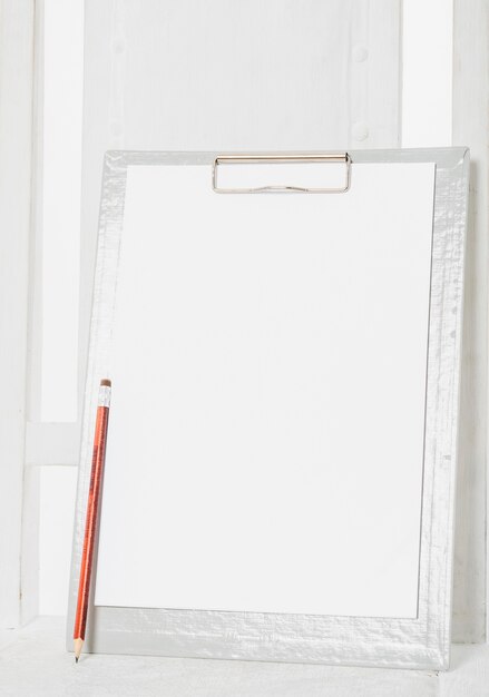 Blank clipboard on wooden chair 