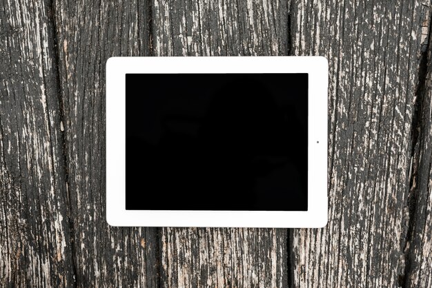 Blank digital tablet device on wooden textured backdrop