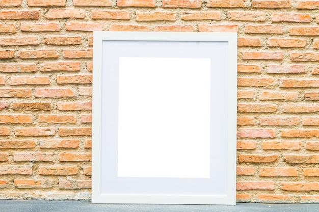 Blank frame on brick wall background