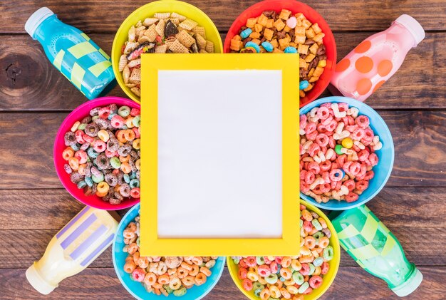 Blank frame on bright bowls of cereals and bottles