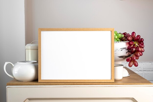 Blank frame next to kitchen tableware