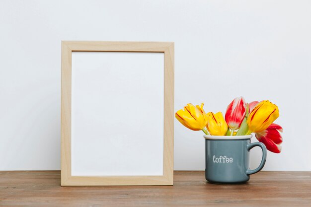 Blank frame near bouquet