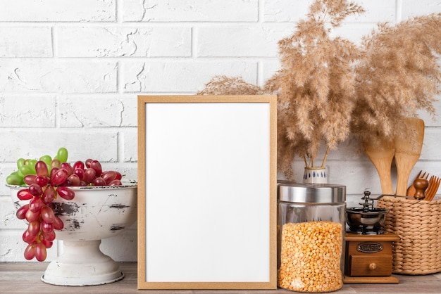 Blank frame on shelf beside flower pots