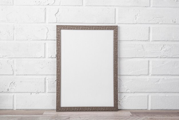 Blank frame on shelf on white wall