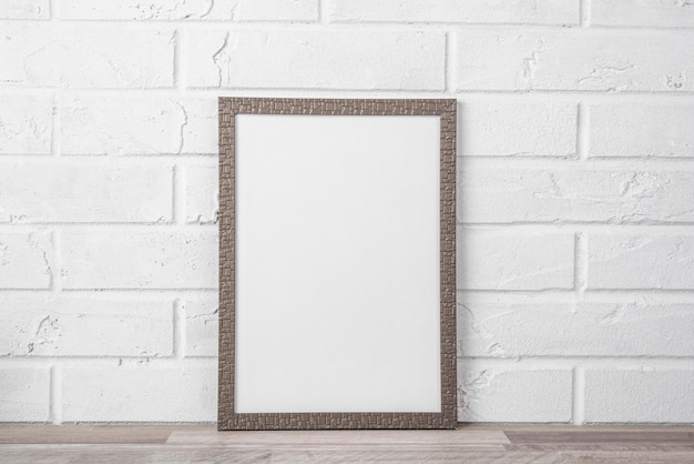 Blank frame on shelf on white wall