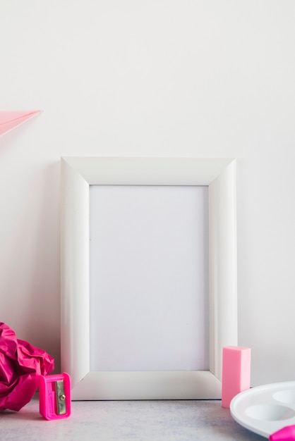 Blank frame and supplies on desk